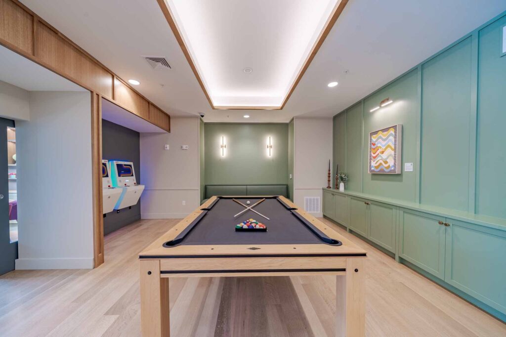 New apartments in Peabody, MA at Alexan Peabody offers lots of amenities like a clubroom with game room, featured is a pool table.