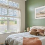 Beautiful spacious bedroom with window bringing in bright light at new apartments in Peabody, MA At Alexan Peabody.